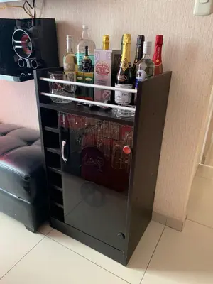 a drink cabinet with bottles of alcohol in it at Peruvian Apartment in Lima