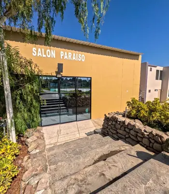 a yellow building with a sign that reads saloon paraiso at El Paraíso Eco Resort in Pisco
