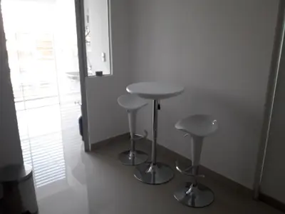 two bar stools in a room with a window at Miraflores Heart Apartment in Lima