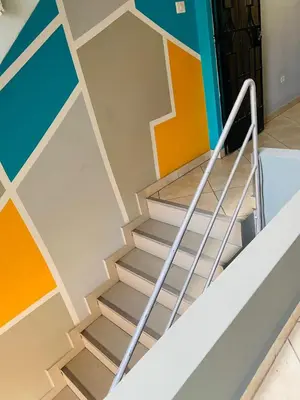 a staircase in a room with colorful walls at Sunset Hostel Airport in Lima