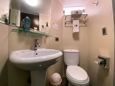 a small bathroom with a sink and a toilet at SM Hotel in Lima