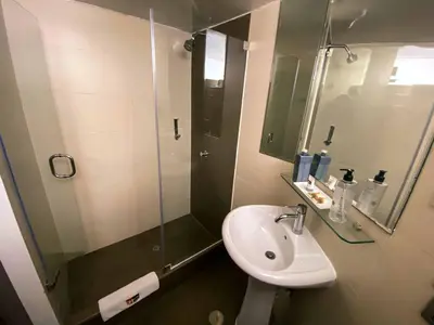 a bathroom with a sink and a glass shower at SM Hotel in Lima