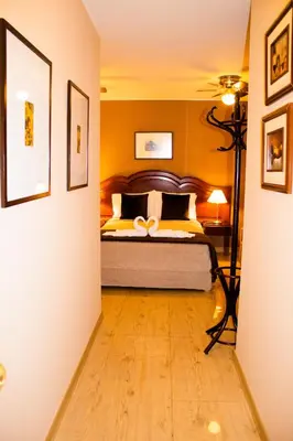 a bedroom with a bed with a wooden floor at Solis Dies Hotel in Lima