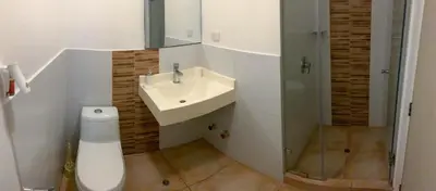 a white bathroom with a sink and a toilet at Condominio Uptown de 2 dormitorios in Lima