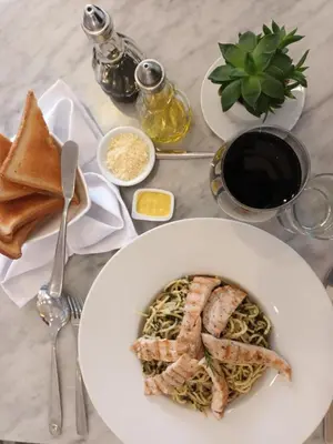 a plate of food with meat and pasta on a table at Hotel Vila Santa in Lima
