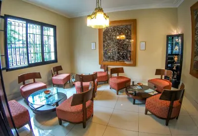 a waiting room with chairs and tables and a waiting room at Hotel Señorial in Lima