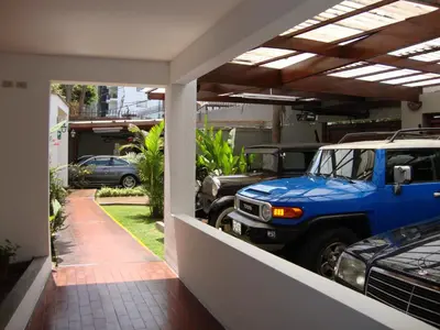 a garage with a blue truck parked in it at Hotel Señorial in Lima