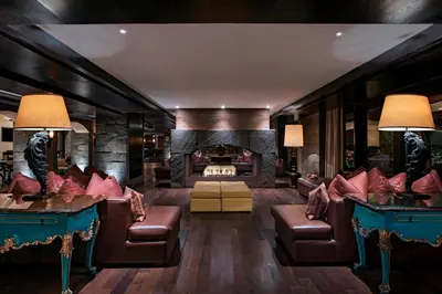 a living room with couches and a fireplace at JW Marriott El Convento Cusco in Cusco