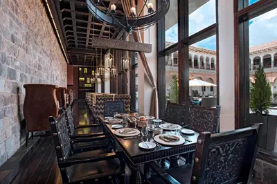a dining room with a long table and chairs at JW Marriott El Convento Cusco in Cusco