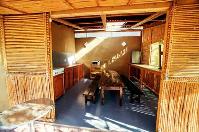 a dining room with a table and a kitchen at Alojamiento Casa Yanantin de Maravilca in Concepción