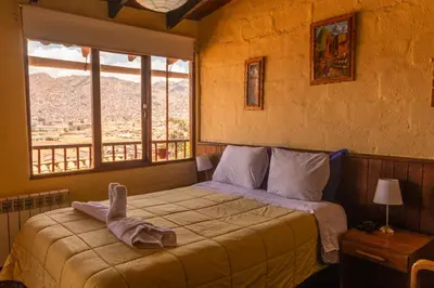 a bedroom with a bed with a towel on it at Samay Wasi Hostel in Cusco