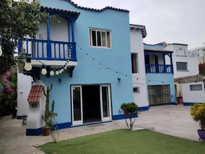a blue and white house with a yard at The Place Miraflores in Lima