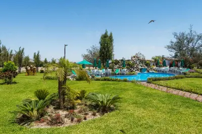a resort with a swimming pool in a park at Casa Hacienda Nasca Oasis in Nazca