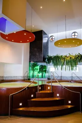 a lobby with stairs and potted plants at Verona Hotel Baños Turcos in Lima