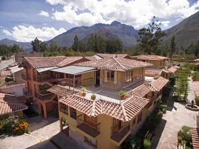 an aerial view of a house with mountains in the background at Hotel Mabey Urubamba in Urubamba