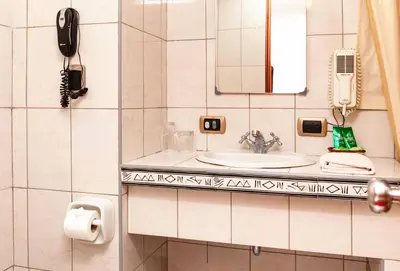 a bathroom with a sink and a phone at Hotel Sol del Oriente Cusco in Cusco