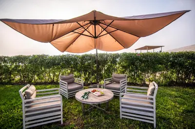 a table with two chairs and an umbrella at Topara Hotel Boutique in San Vicente de Cañete