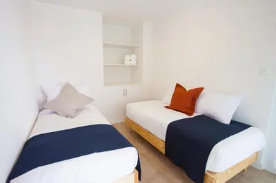 two beds sitting next to each other in a room at Lima Walking Apartments - Central Miraflores in Lima