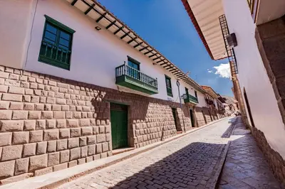 a cobblestone street in an old town at Hotel Hacienda Sonqori Centro Histórico in Cusco