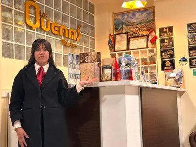 a woman is standing in front of a counter at Hotel Las Quenas in Cusco