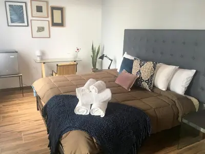 a bedroom with a bed with towels on it at Belma Boutique Bed and Breakfast in Lima