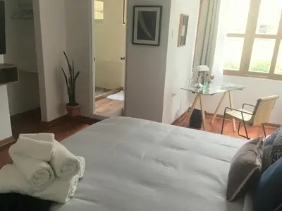 a bedroom with a large white bed with towels on it at Belma Boutique Bed and Breakfast in Lima