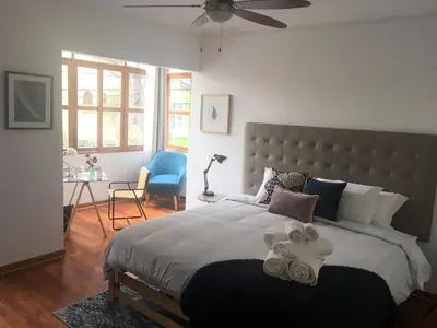 a bedroom with a large bed with towels on it at Belma Boutique Bed and Breakfast in Lima