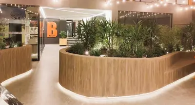 a lobby with a large planter with plants in it at LA POSADA DE GUILLE LUXURY 1 HABITACION - Surco in Lima