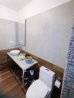 a bathroom with a white toilet and a sink at LA POSADA DE GUILLE LUXURY 1 HABITACION - Surco in Lima