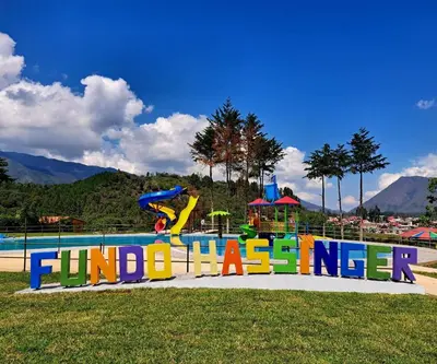 a playground with a sign that reads jump in theinger at Fundo Hassinger in Oxapampa