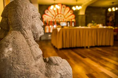 a statue of a statue of a person in a room at Hotel Warari in Cusco