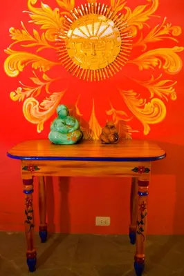 a table with a mirror on a red wall at Hotel Warari in Cusco
