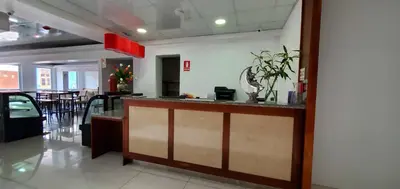 a lobby with a counter and a dining room at La Luna Inn in Lima