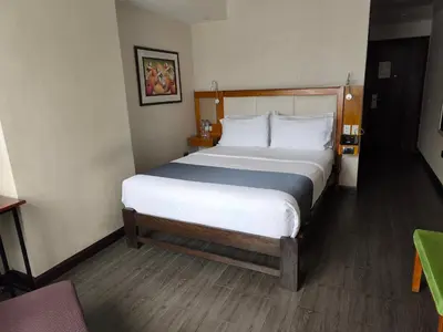 a bedroom with a large bed in a hotel room at La Luna Inn in Lima