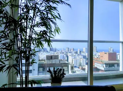 a large window with a view of a city at MIRAFLORES LUXURY PLACE POOL GYM 2BD in Lima