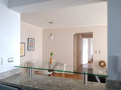 a glass table in a kitchen with a dining room at MIRAFLORES LUXURY PLACE POOL GYM 2BD in Lima