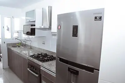 a kitchen with a large stainless steel refrigerator at MIRAFLORES LUXURY PLACE POOL GYM 2BD in Lima