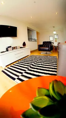 a living room with a couch and a table at MIRAFLORES LUXURY PLACE POOL GYM 2BD in Lima