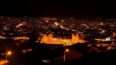 a view of a city at night with lights at Cuzco Central Hostel in Cusco