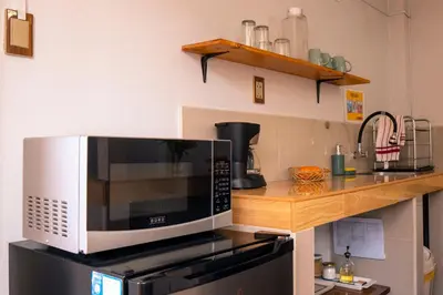 a microwave oven sitting on top of a stove at Casa Samaykuy in Ayacucho