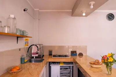 a kitchen with a sink and a counter top at Casa Samaykuy in Ayacucho