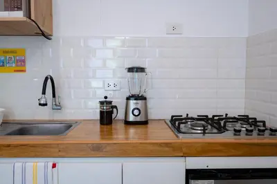 a kitchen counter with a blender on top of a stove at Casa Samaykuy in Ayacucho