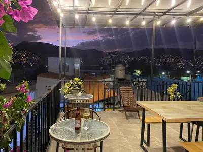 a patio with tables and a view of a city at Casa Samaykuy in Ayacucho