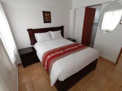 a bedroom with a large bed in a room at Apartment Samana House in Cusco
