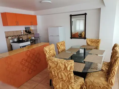 a kitchen and dining room with a table and chairs at Apartment Samana House in Cusco