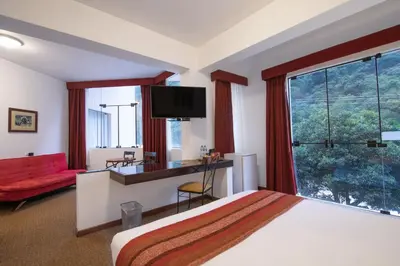 a hotel room with a bed and a large window at Tierra Viva Machu Picchu Hotel in Machu Picchu