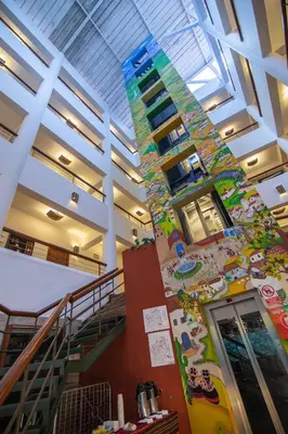 a staircase in a building with a colorful wall at Tierra Viva Machu Picchu Hotel in Machu Picchu