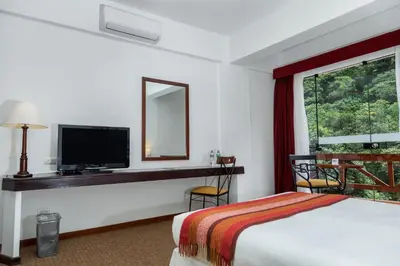 a hotel room with a bed and a flat screen tv at Tierra Viva Machu Picchu Hotel in Machu Picchu