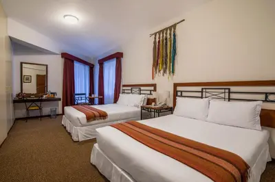 a hotel room with two beds and a mirror at Tierra Viva Machu Picchu Hotel in Machu Picchu