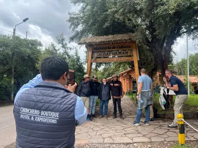 a group of people standing in front of a gate at Hotel Chinchero Boutique & Tours in Chinchero